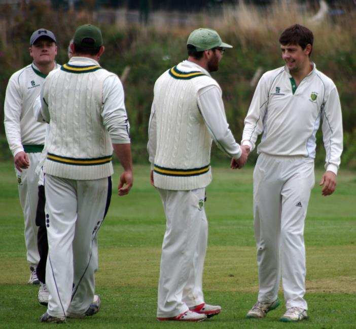 Burton skipper Morgan Scale congratulates Luke Hayman for taking the wicket of Goodridge