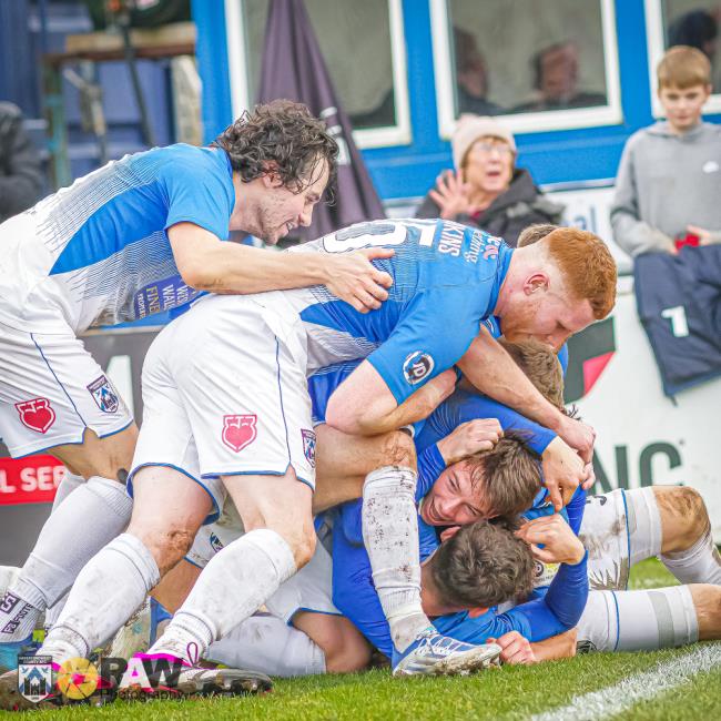 Rhys Abbruzzese is smothered by team-mates after he opened the scoring for Haverfordwest County