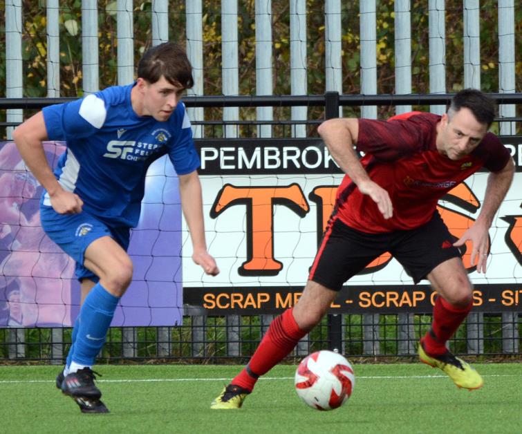 Bridge goal scorer Tomos Gwilliam closely marked by Clarby player manager Matthew Ellis. Picture Gordon Thomas