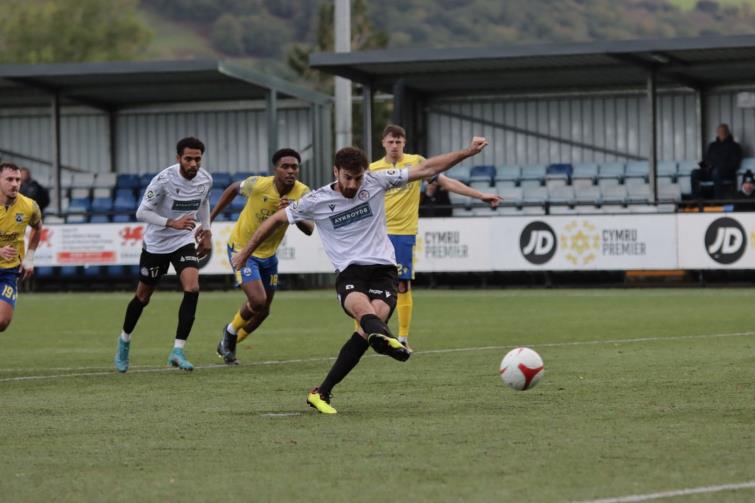 Man of match George Newell scores from the spot
