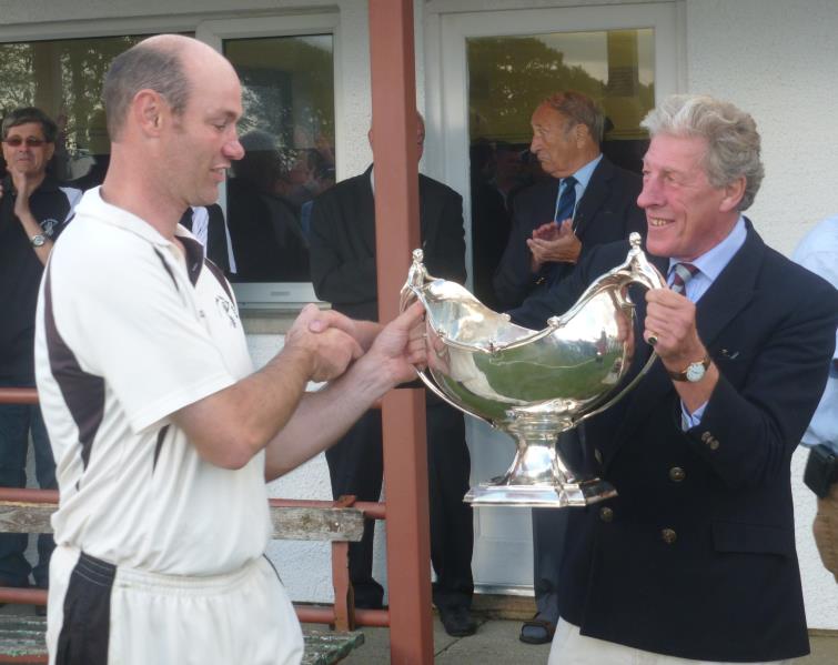 Gregg Miller receives the bowl from Hugh Harrison-Allen