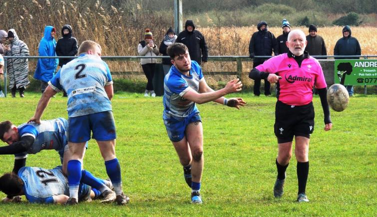 Scrum half Max Jones gets his backs moving