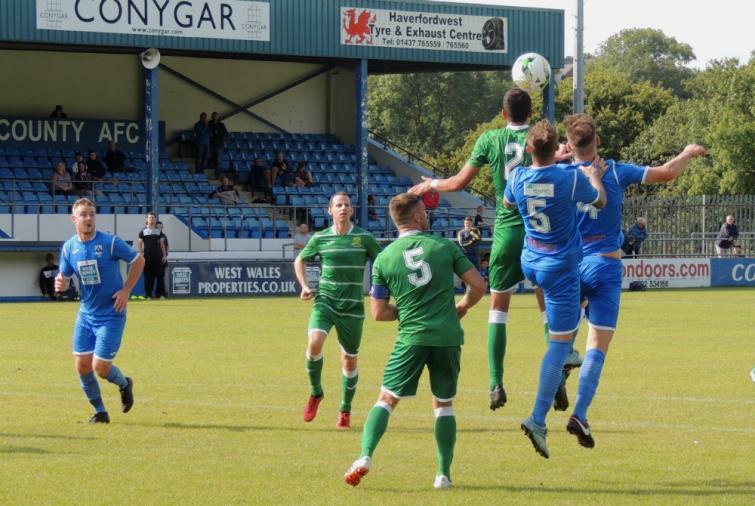 Bluebirds centre backs Sam Rodon and Sean Pemberton strongly contest in the aerial stakes