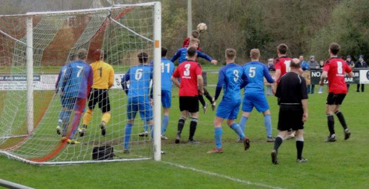 Scott Delaney contests a header at a corner