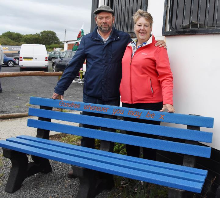 Luke Hardings parents with a bench in memory of their son