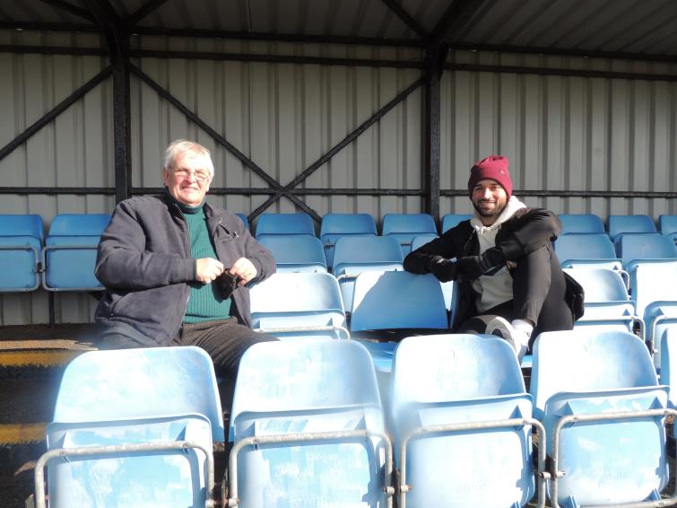 Richards sits watching the game with former chairman David Hughes