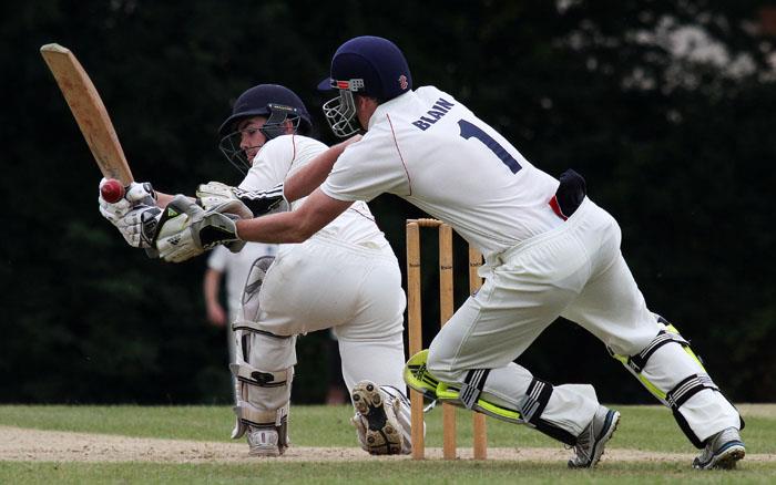 Dafydd Bevan guides the ball just beyond the reach of  Dylan Blain