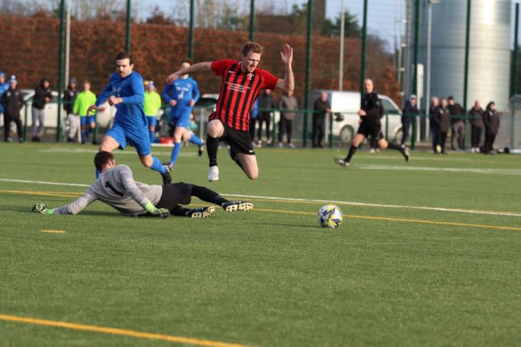 Rhys Dalling skips past James Dickson to fire in the second for Goodwick. Picture Matthew Watters Photography