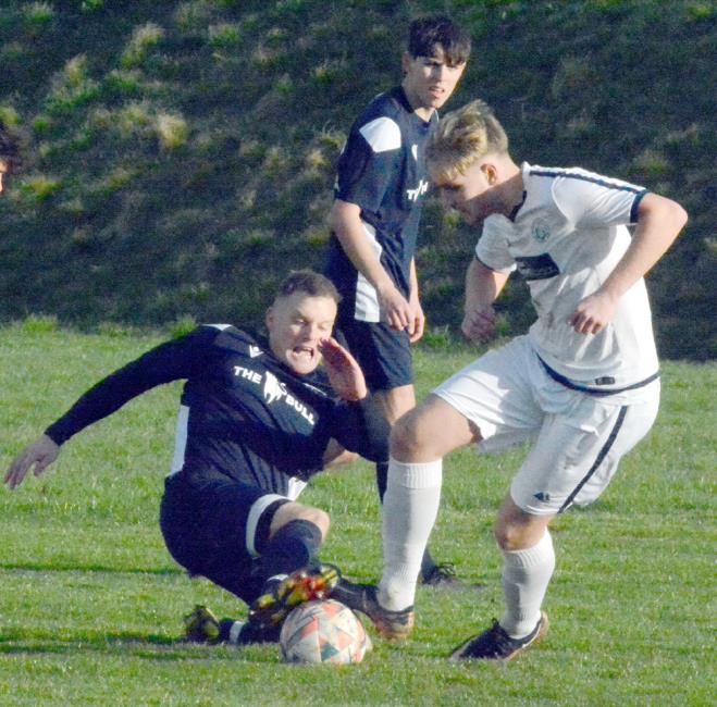 Bridge midfielder Dai Davies puts in a strong tackle against Fishguard Sports