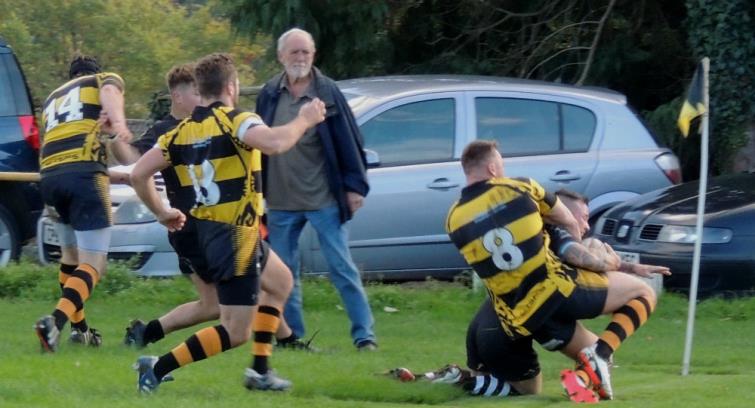 Delme Bateman squeezes over for a try for Neyland