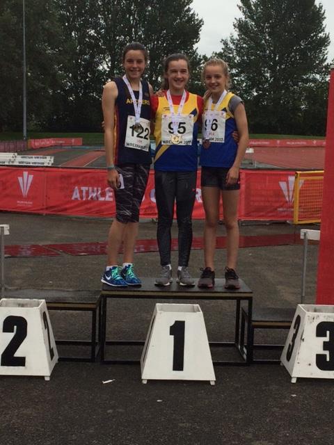 Ella standing on the winners  podium