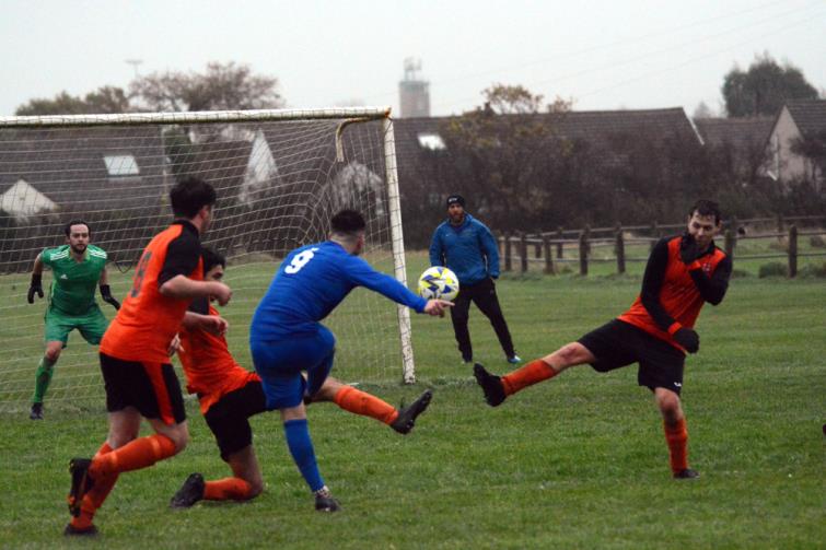 Scott Ferney scores the third goal for Merlins Bridge