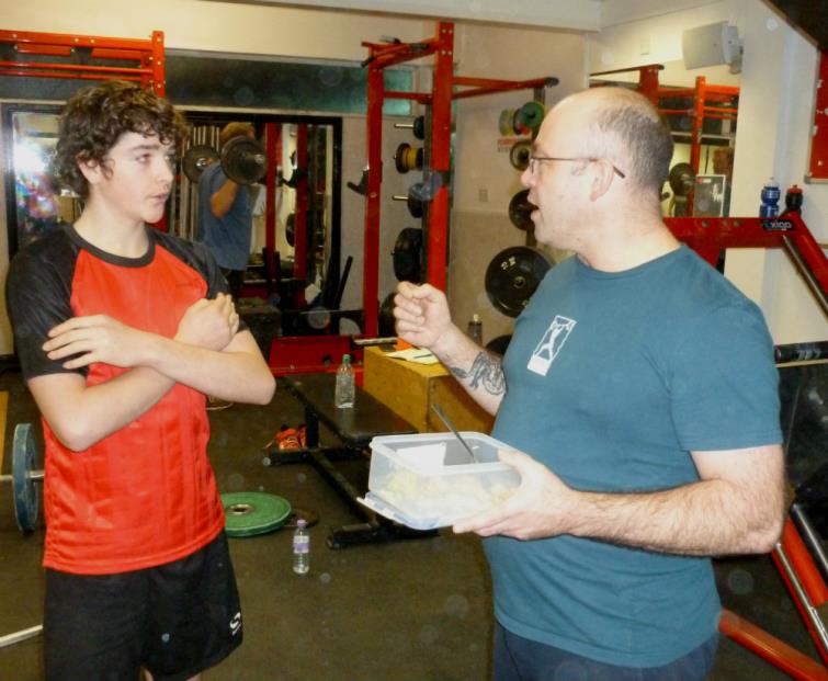 Freddy takes advice from coach Justin Head