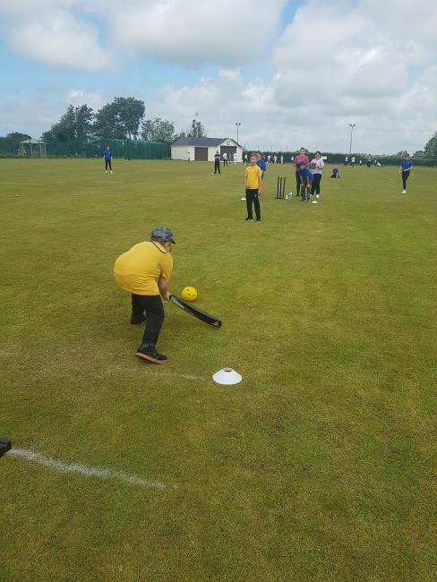 Gethyn Griffiths, a partially sighted Neyland Community School pupil, plays a lovely shot to the leg side. The pupils are using a large ball with a bell in.