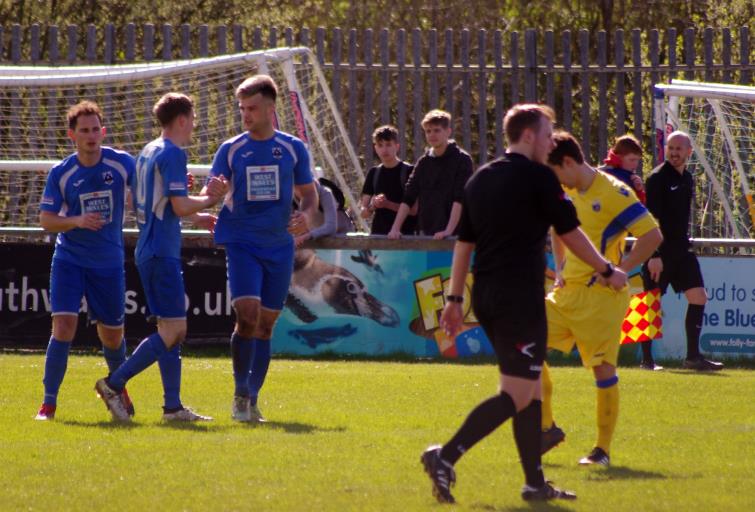 Rhys Dalling and Kristian Speak congratulate goal scorer Ashley Bevan