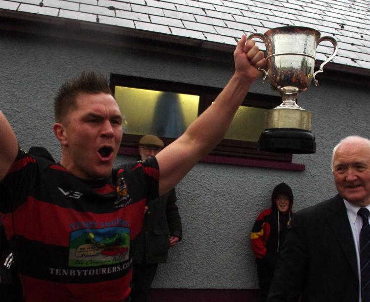 Luke Hansford holds cup aloft