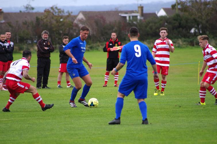 Daniel Bryce is in possession for the Wizards against Trefelin BGC