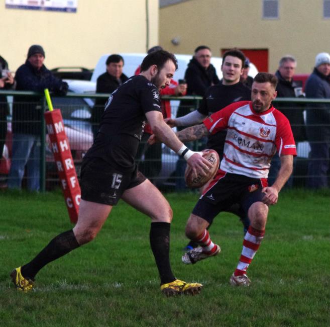 Neyland full back Patrick Bellerby kicks for touch