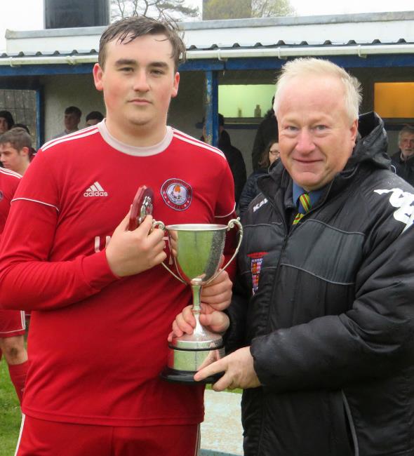 Milford skipper Owen Wilson collects cup off Steve Briers