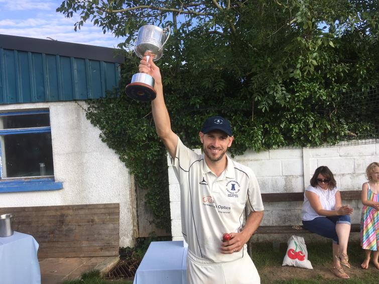 Town 3rds skipper Paul Jenkins holds cup aloft