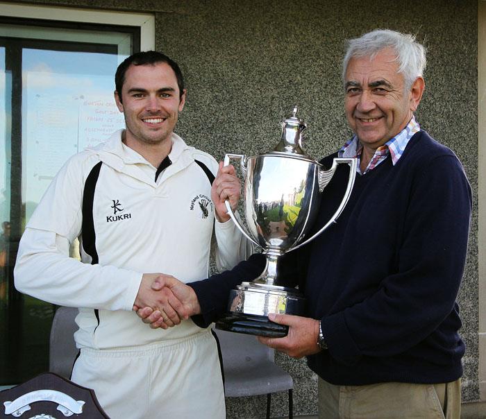 Graham Morris hands cup to Neyland skipper Sean Hannon