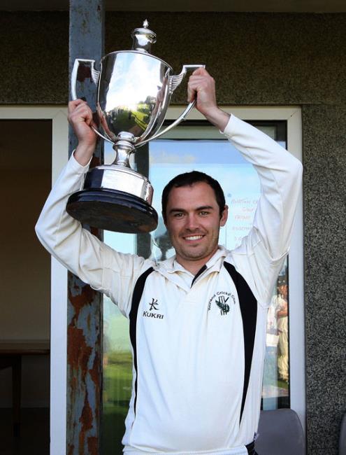 Neyland skipper Sean Hannon holds the silverware aloft