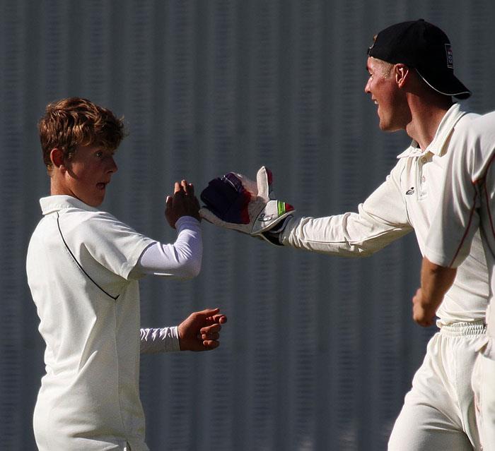Tom Mansbridge and Ashley Murdoch celebrate taking a wicket off Toms bowling.