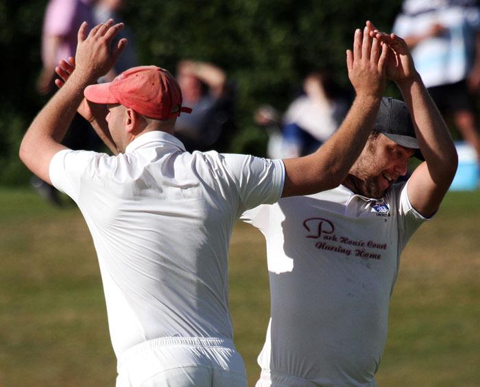 James and Danny Caine celebrate taking a wicket off Dannys bowling