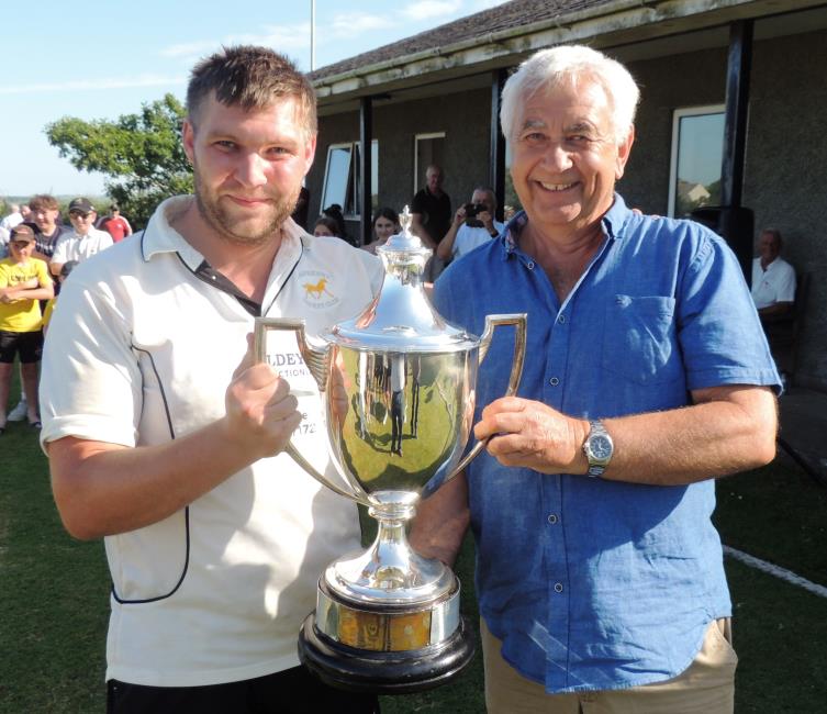 Joe Kidney receives the trophy from Graham Morris