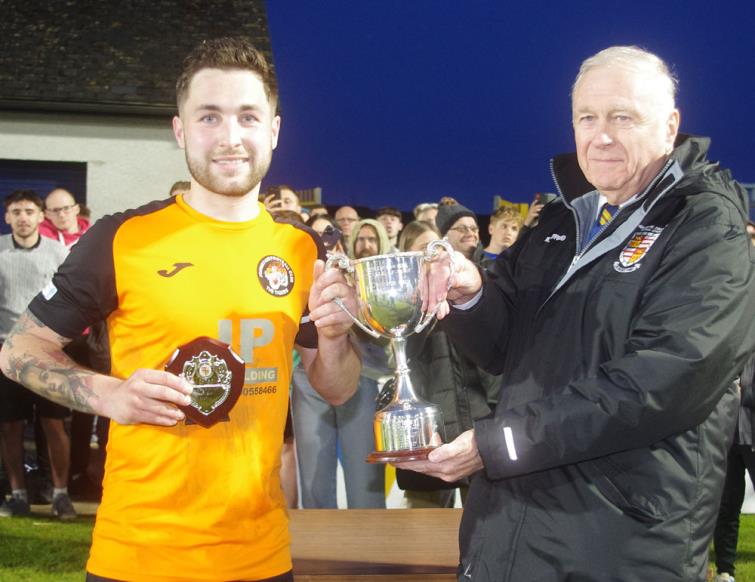 Johnston captain Joey George receives silverware from Pembroke League Council chairman Mike John