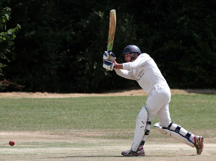 John Mansbridge strikes the ball to the boundary