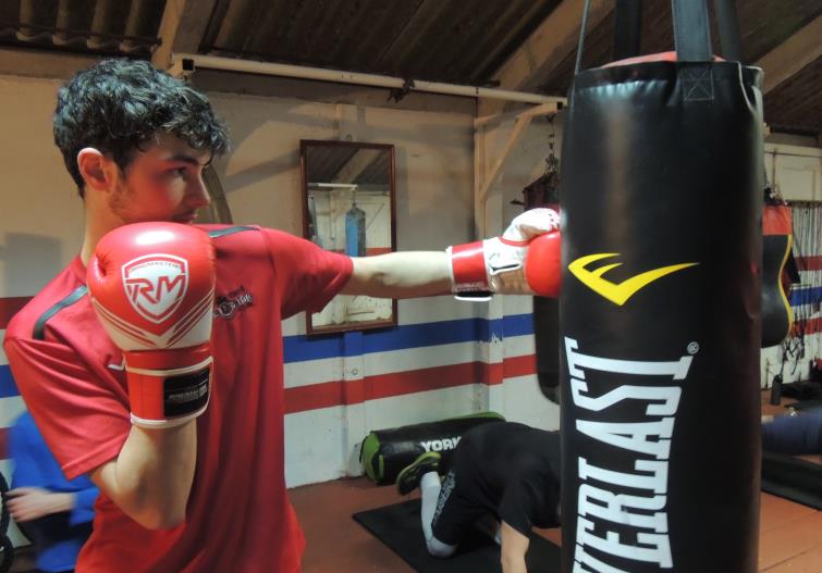 Joseph punches on the heavy bag