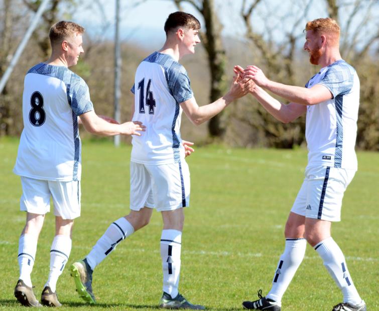 Fishguard Sports two-goal hero Jack Griffiths is congratulated by captain Patrick Hughes. Picture Gordon Thomas