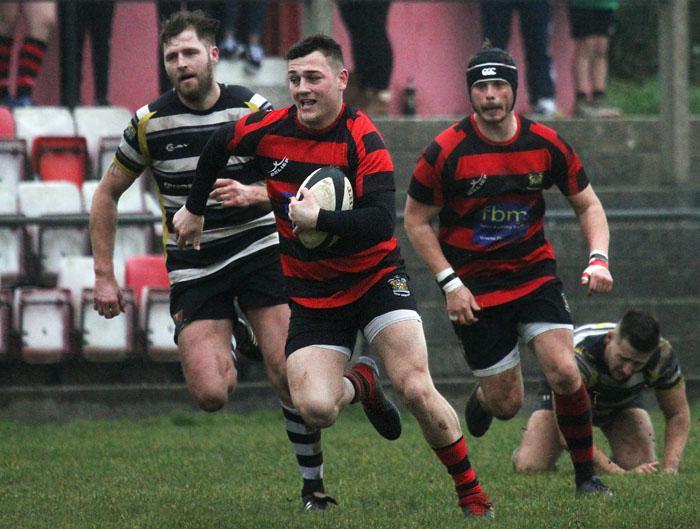 Tenby full back Jack Tucker breaks