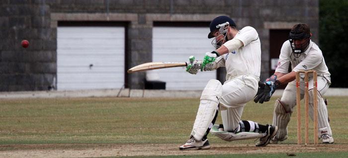 Jake Griffiths smashes a shot to the boundary