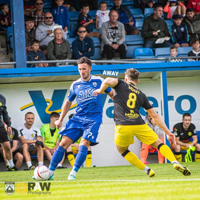 Ricky Watts in action against Caernarfon Town on Saturday, scored a stoppage time brace at Barry Town United on Tuesday night