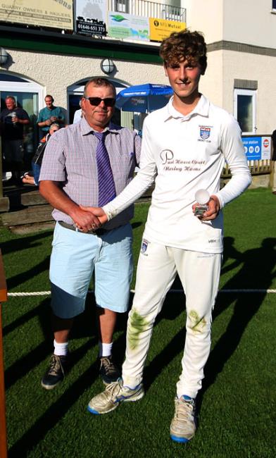 Tom Mansbridge collects the man of the match trophy from Micky Marsh