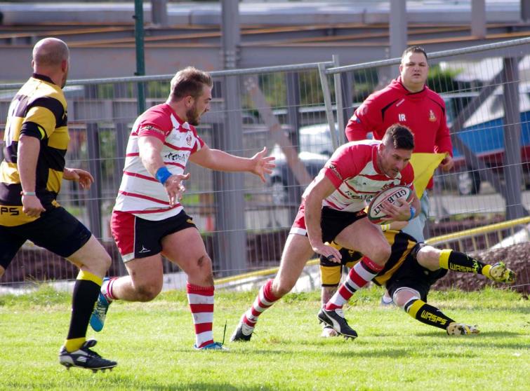 Lee Riley breaks a tackle as the full back scores for the Mariners Lee Riley breaks a tackle as the full back scores for the Mariners