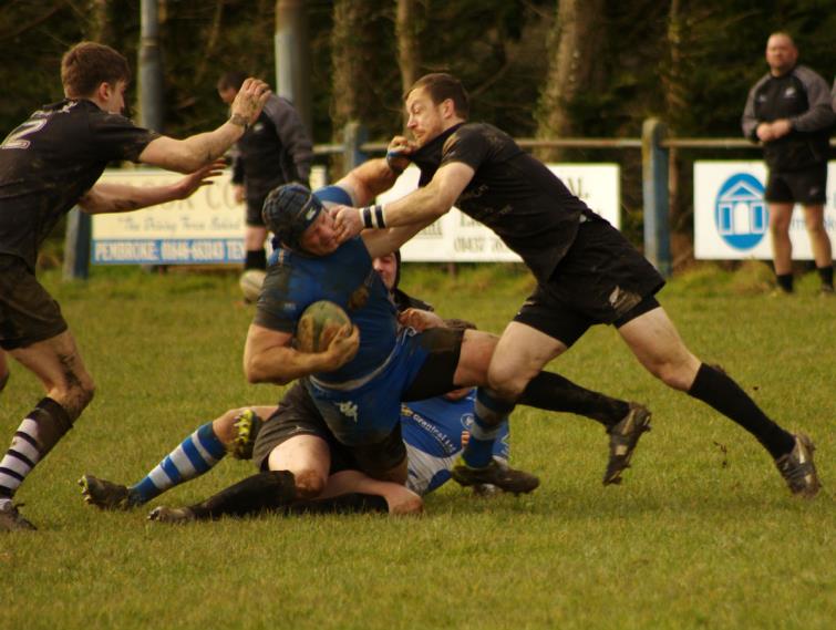 Blues try-scorer Lewis Wood is hauled down by Neylands Steve Martin