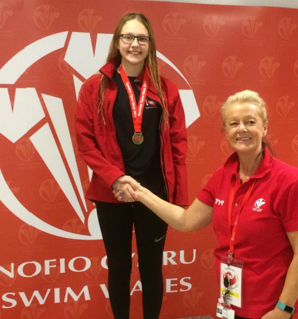 Lucy receives one of her three swimming medals