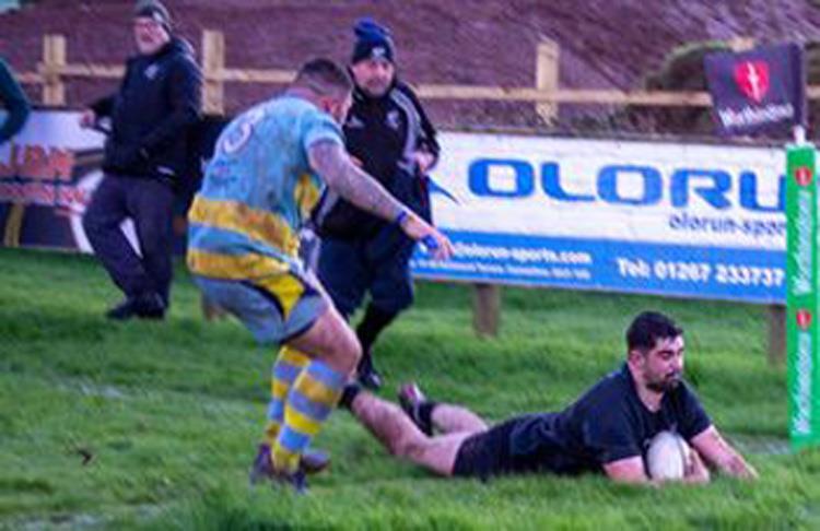 Luke Griffiths-Dawes - dives over for a try for Neyland. Picture by Colin Picton