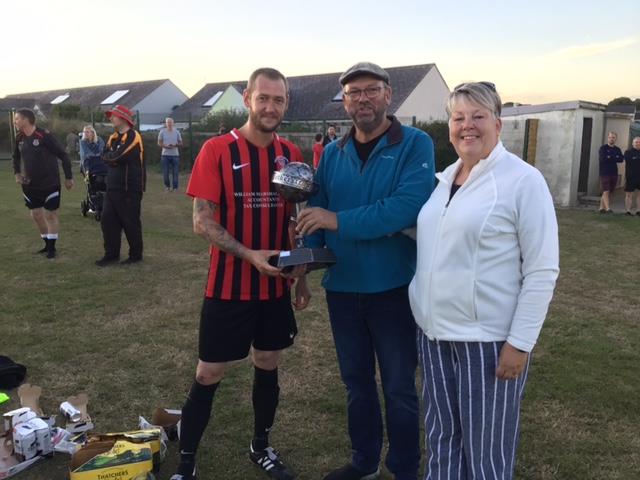 Goodwick United 2nds skipper Danny Williams receives the Luke Harding Trophy from Lukes parents Pete and Alex