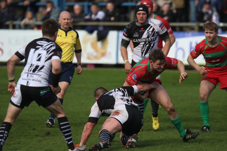 Matthew breaks through a tackle