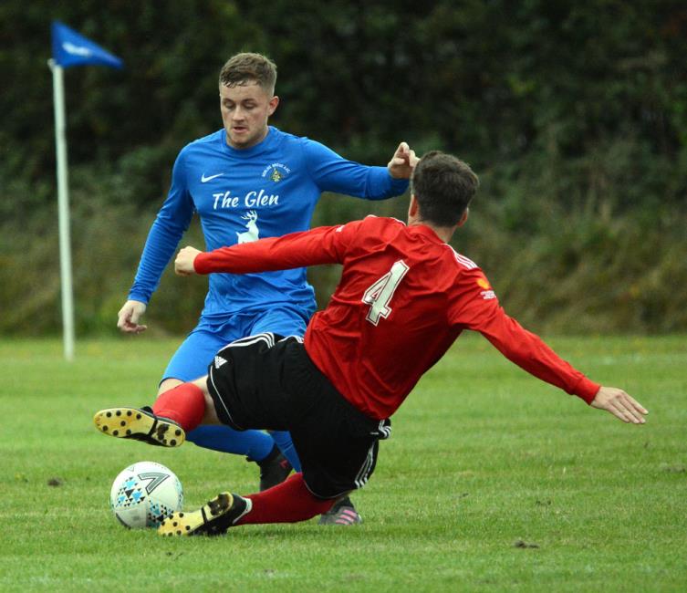 Gareth Lewis puts in a strong tackle on Leon Pemberthy