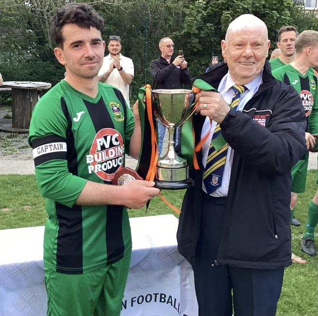 Solva 2nds captain Luke Jones receives the silverware from Trevor Morgans