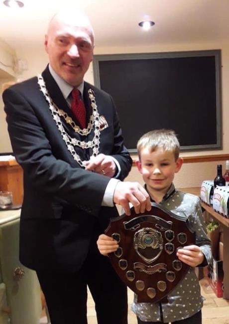 Son Noah receives his cheque from Cllr Simon Hancock, the vicar of Neyland