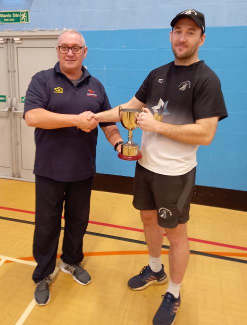 Patrick Bellerby receives the trophy from Sean Evans