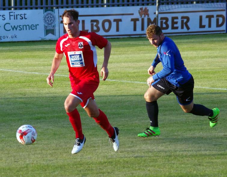Kristian Speake gets to the ball first