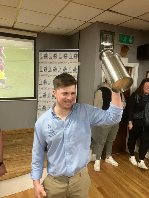Will Davies raises the trophy aloft