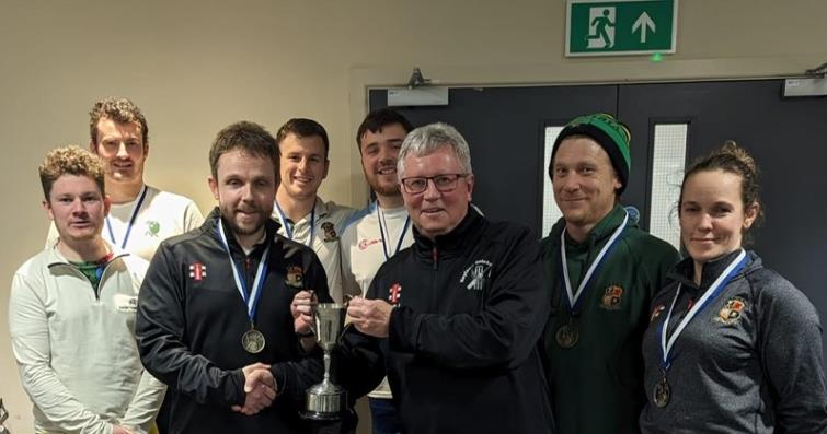 Winners Pembroke 2nds receive the trophy from Martin Jones